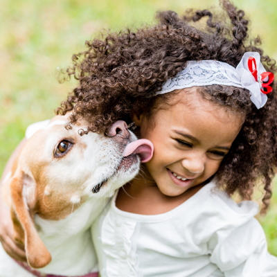 Girl Being Licked by Dog